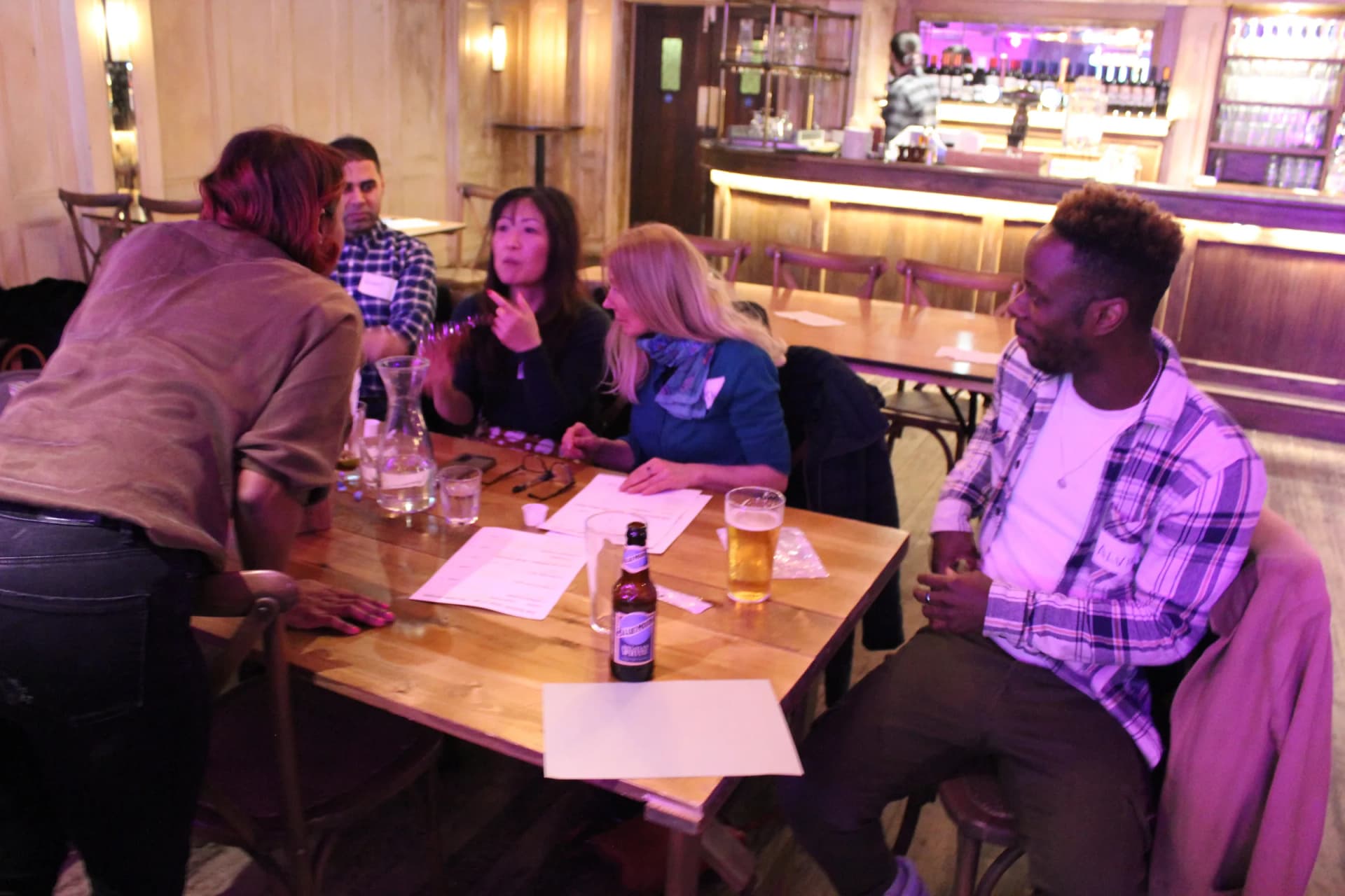 Host dropping by a team's table mid-quiz.