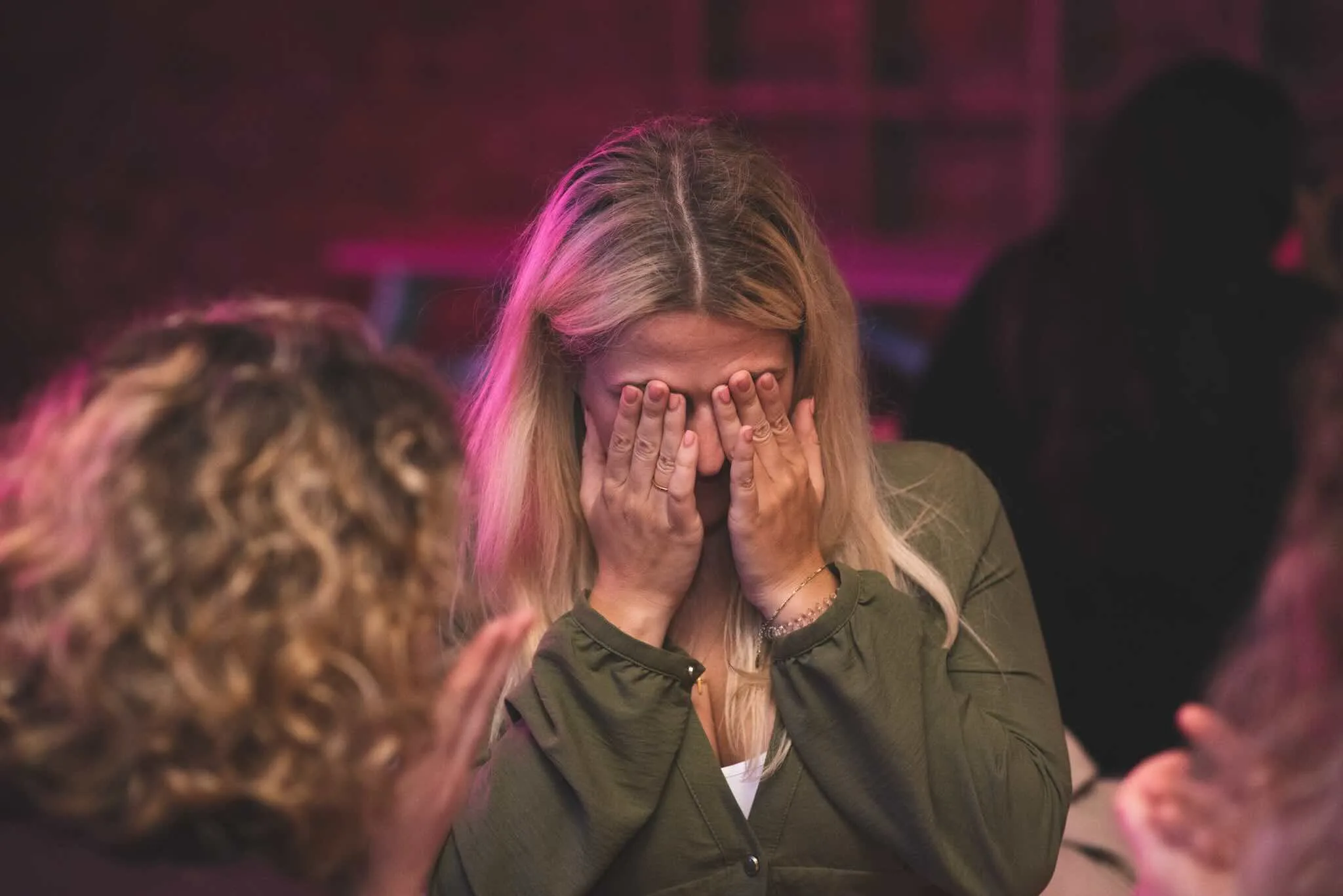 Guest covering her face in mock despair at the quiz table.